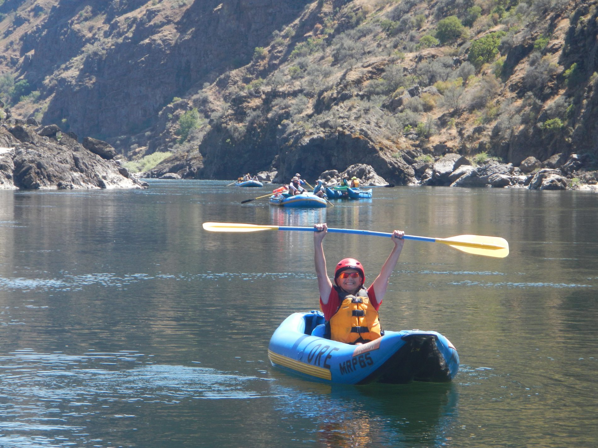 Person holding paddle in air on salmon river.